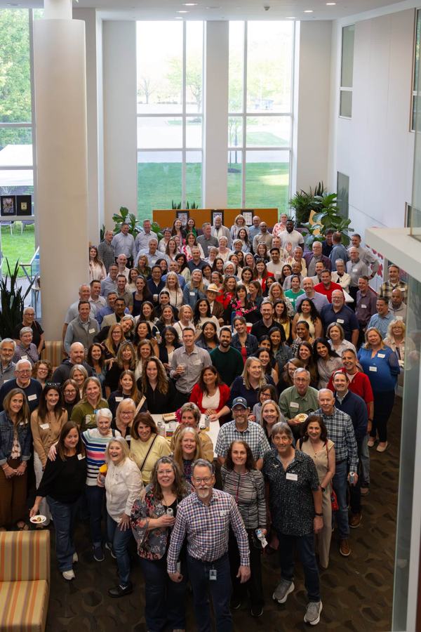 A crowd gathered for a group photo, seen from above