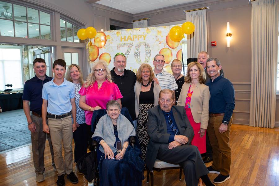 Family gathered around the guest of honor at a milestone birthday