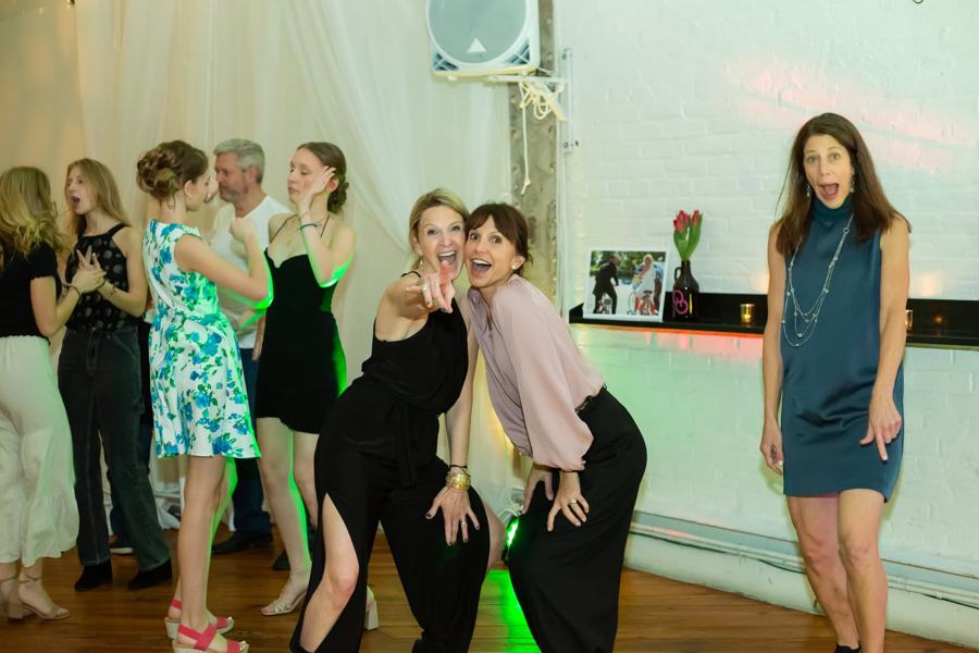 Friends laughing and dancing at a party