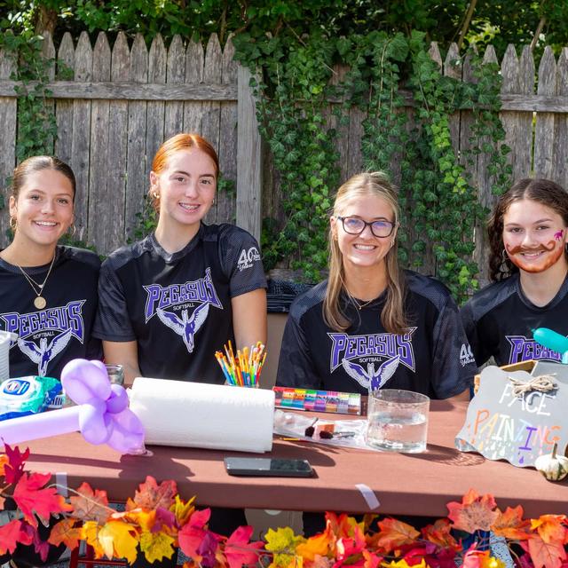 Team volunteers at a decorated autumn table